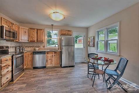 Granite countertops, all new stainless steel appliances, and hickory cabinets make this classic kitc