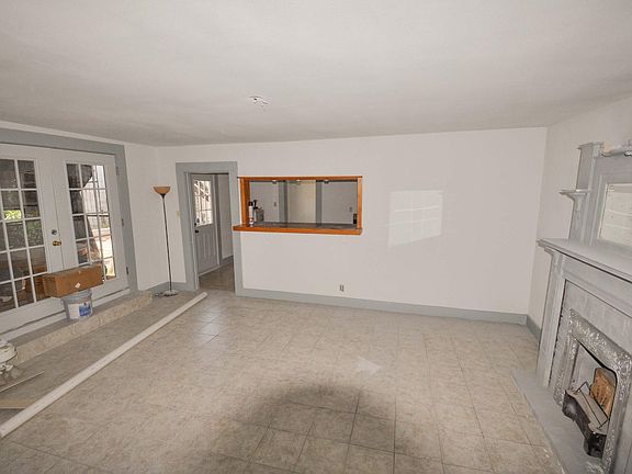 Huge living room area with french doors leading to a screened in porch and pass through bar to kitchen.