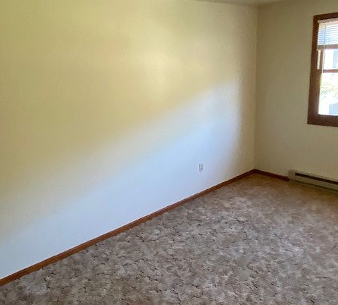 The large bedroom has a picture window and a large closet and a separate entrance to the full bathroom.