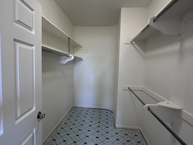 Primary bedroom walk-in closet.