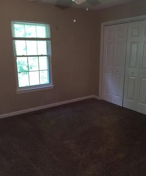 This bedroom is located in the middle of the back side of the house. It also has a large closet.