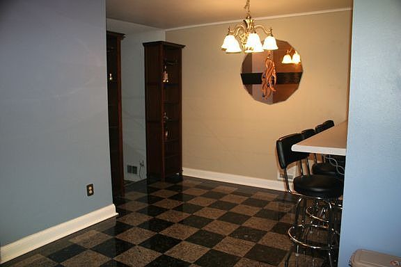 Dining Room with Updated Lighting and Granite Flooring