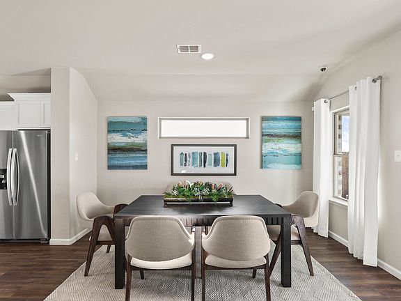 Dining room in the Heisman home plan by Trophy Signature Homes - REPRESENTATIVE PHOTO