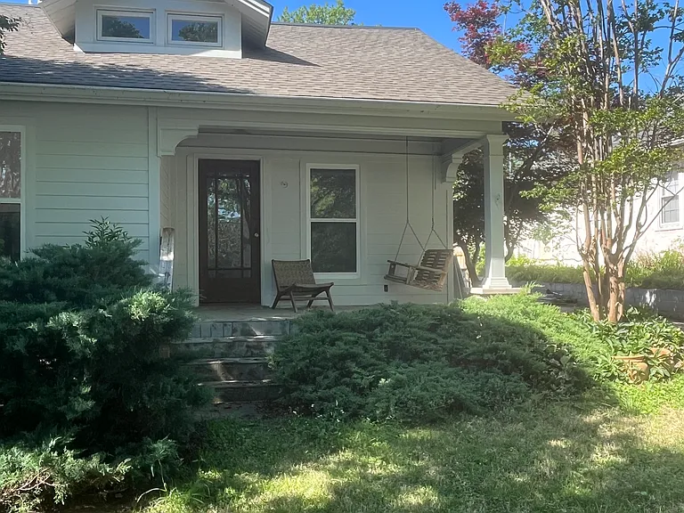 Lovely front porch with swing. Watch the neighbors walk by with their dogs.