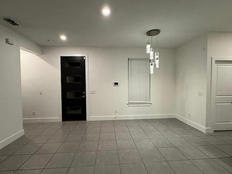 View of Living Area from sliders. Front door visible.