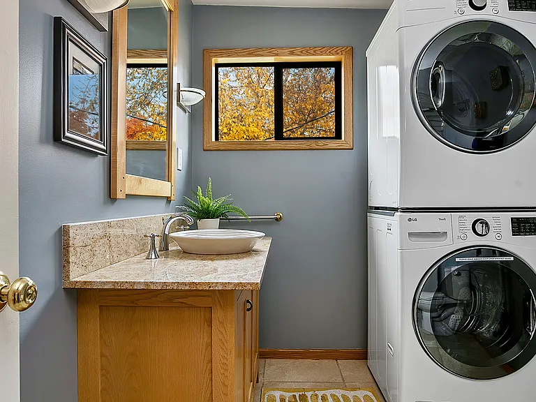Bathroom with washer and dryer outside third bedroom.