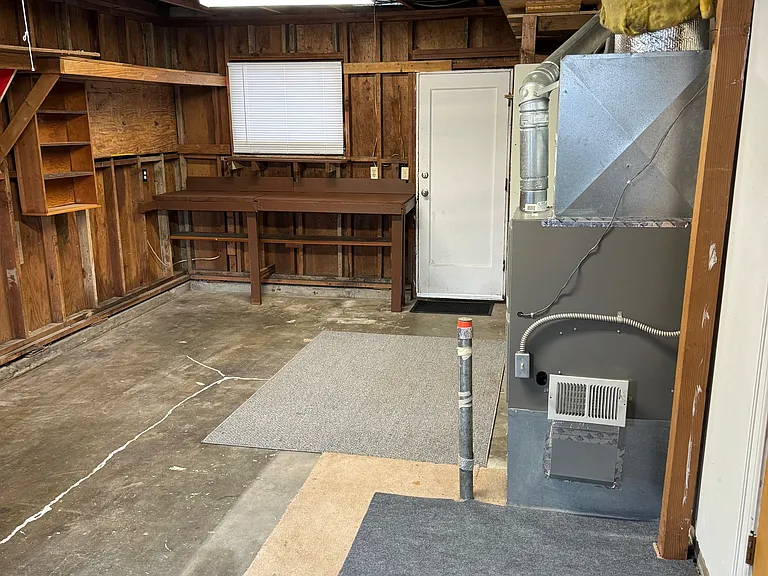 Garage/Storage shelving/Work bench/access to back yard.