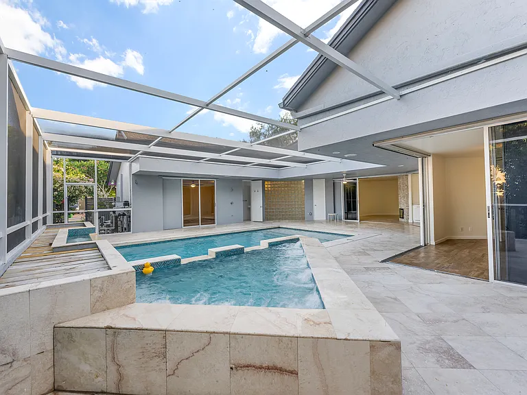 Rare courtyard design with direct pool access and views from throughout the home.