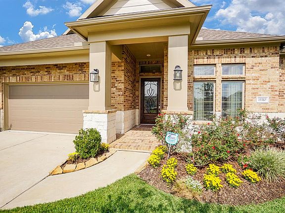 Covered front porch elevation including 3 car tandem garage