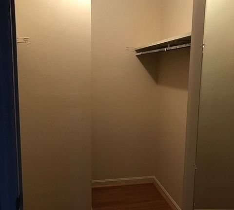 Very large walk in closet in master bedroom. Clothing racks