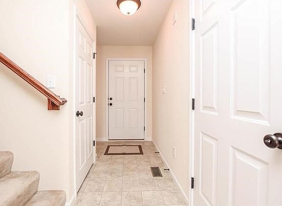 Entry foyer freshly painted with neutral color and white trim.