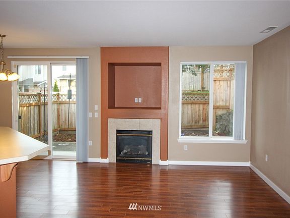 Living room Fireplace with entertainment niche.  Slider to back patio/yard.