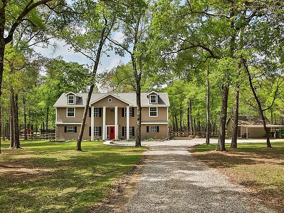 Nestled in the trees and set back from the road in a very relaxing and tranquil setting. Located on a very quiet cul-de-sac street with little passing traffic in sought after Woodlane Forest which is a deed restricted neighborhood comprising many cou