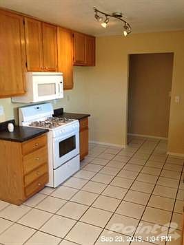 Kitchen. New Range and Microwave. Tile Floors and upgraded lighting on ceiling.