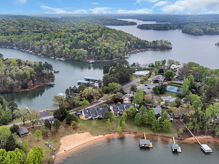 Community lake area with beach, rentable boat slips, and lake access