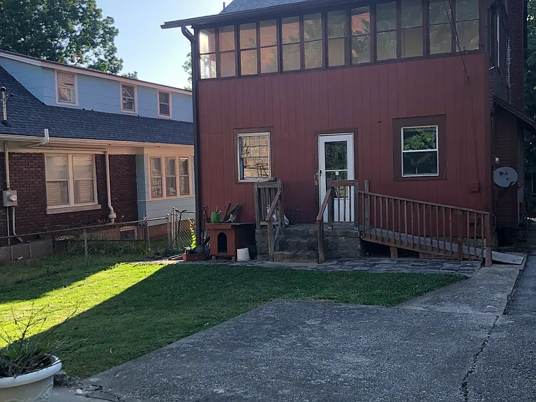 Back yard with patio, small ramp up to the back door (built for my grandmother to easily walk up instead of going up the steps). Back view of sun porch room.