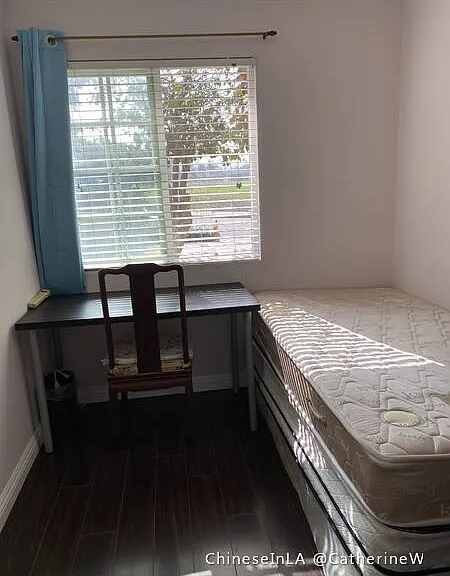 Room 3. Twin bed, desk and chair, wall-hung TV, closet.