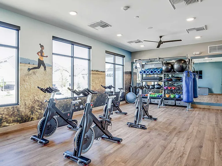 Stay active with access to The Wright's dedicated fitness studio featuring spin bikes, functional training equipment, and open space for strength, cardio, and wellness routines.