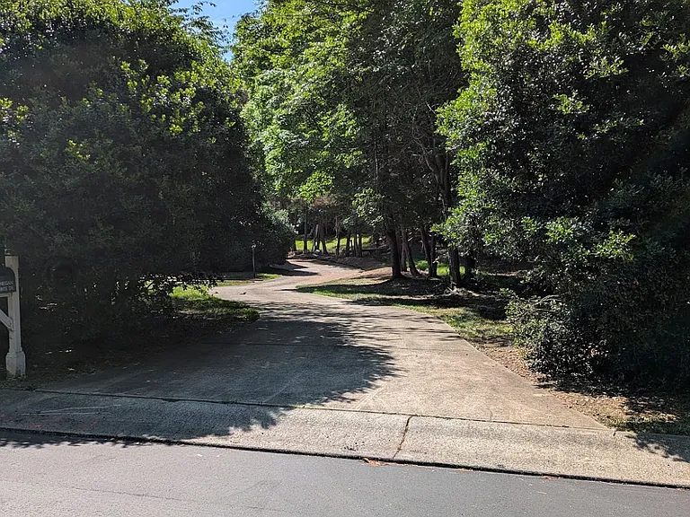 View from street (recently repaved). The house cannot be seen from the street unless entering the driveway.