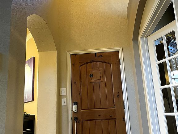 Welcoming foyer with arched openings and soaring ceilings