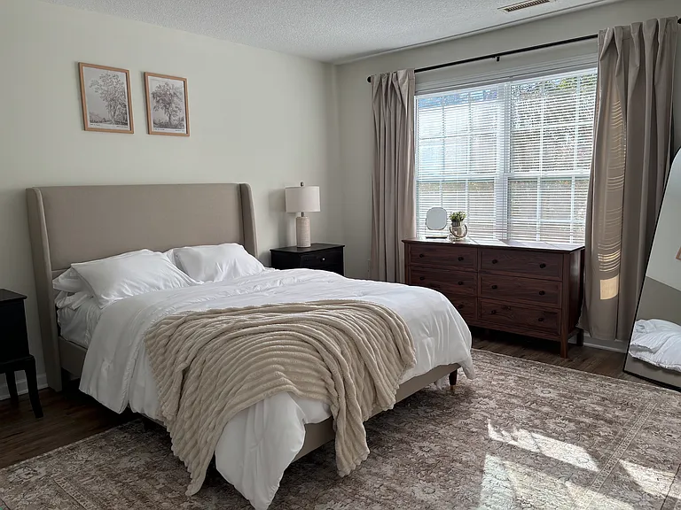Bedroom two/primary bedroom from model unit, same floorplan. Easily fits king size bed.