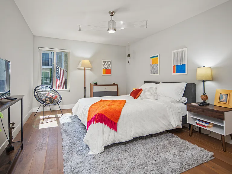 Primary bedroom with TV, private bath and walk-in closet.