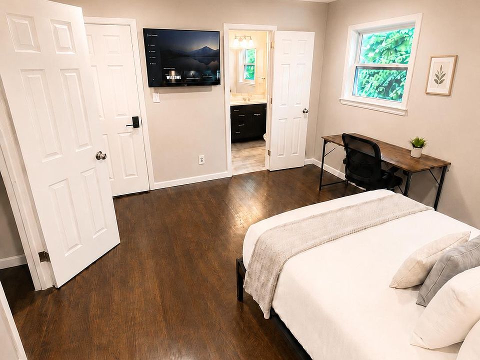 Settle into this stylish private room with a comfy bed, work desk, and mounted TV.