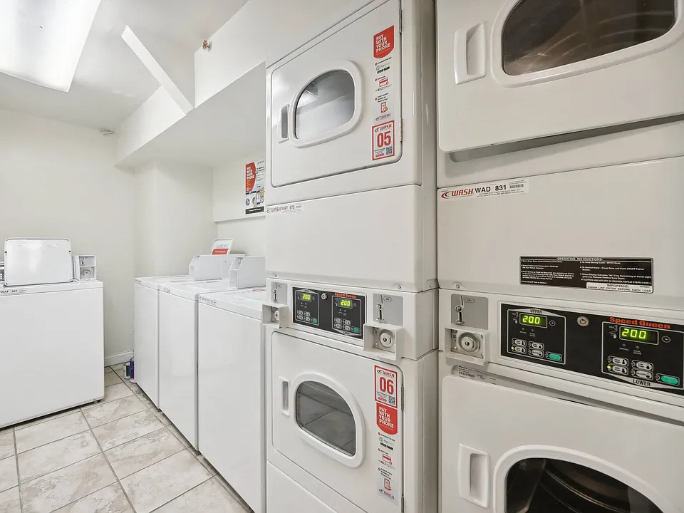 Laundry room with washing machines neatly arranged on a wooden floor