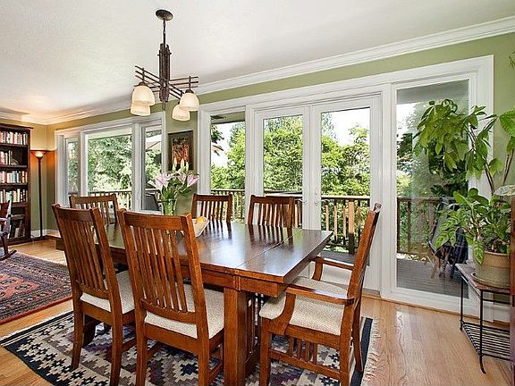 Light & bright dining room with a wall of windows. French doors leading to large entertaining deck.