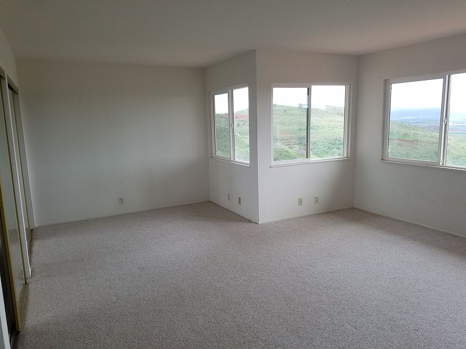Standing at the wall next to the sink, looking across the room. See the hillside out the windows.