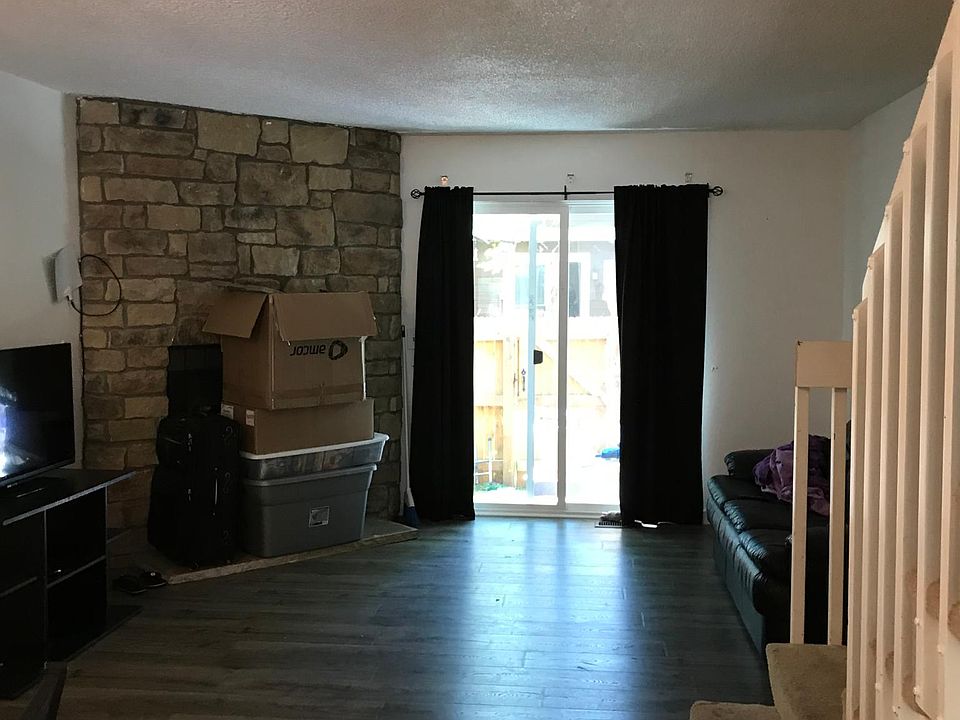 Main living area leading to patio with storage closet and private fence.