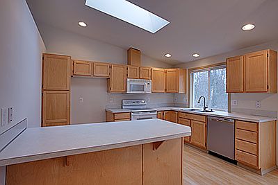 Close-up view of the kitchen. The cabinets look like new and there are plenty of them. The range & m