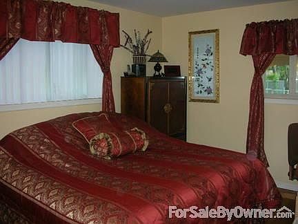 Master bedroom holds king size bed.