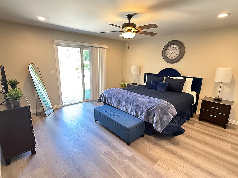 Primary bedroom viewed from bath door. Patio yard can be accessed by sliding door.