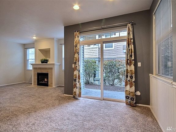 Note the lovely bead board wainscotting, tile fireplace surround, and new carpet. Just some of the great updates in this home. 