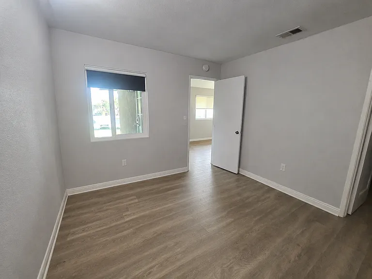 Main Bedroom door to living area and porch window.