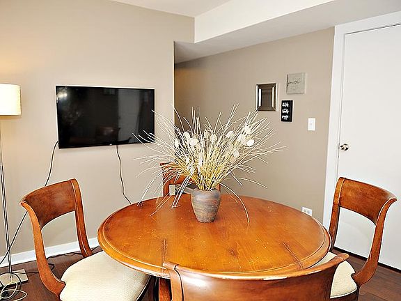 Living room with door to bedroom 1 and hallway to kitchen/bedroom 2/dining room.