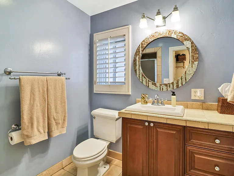 Bathroom adjacent to third bedroom--includes shower with floor to ceiling Travertine tile.