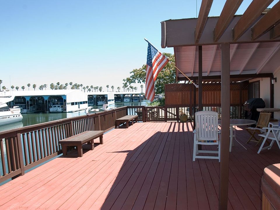 Large deck with view of marina and palm trees