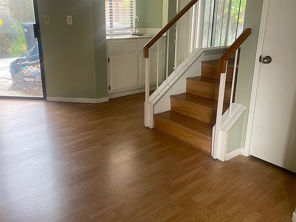 Living room leading to stairs and bar
