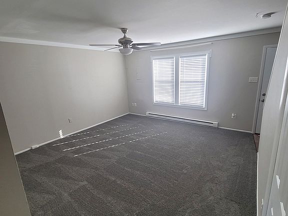 Living room with new carpet, freshly painted and new ceiling fan