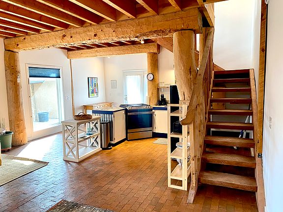 Open Plan Kitchen and Staircase leading to Upper Bedroom Area