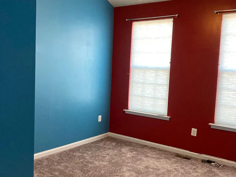 Second bedroom with ceiling fan and vaulted ceiling HAS BEEN REPAINTED TO NEUTRAL COLOR.