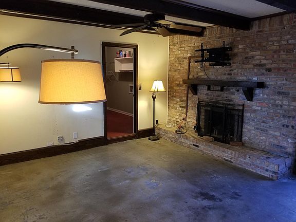 Den with fireplace. Door to utility room.