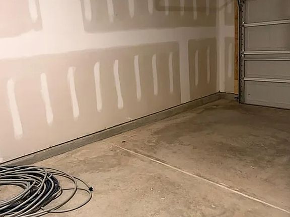 Street-facing, 1- car garage with BEV charger installed