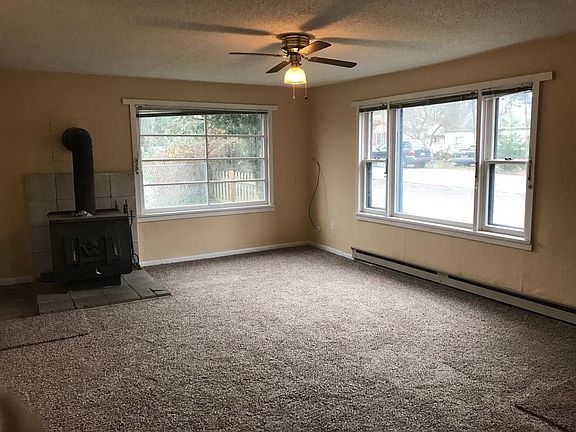 Bright and sunny living room with woodburning stove