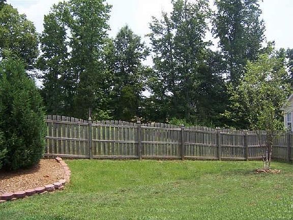 Fenced in back yard with patio