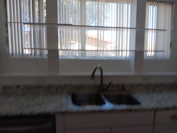 Kitchen with large window over sink.