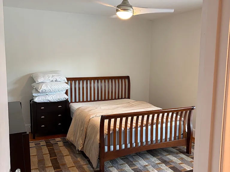 Bedroom 1; 2 closets, 1 queen bed, dresser, desk, leads to patio.