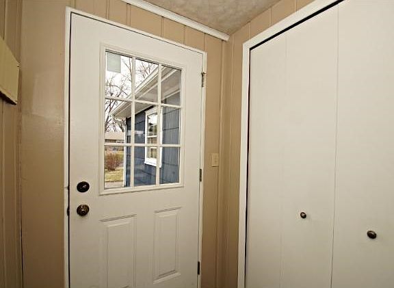 Large living room with wood burning fireplace and gleaming hardwood floors!